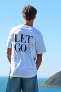 Person wearing a white t-shirt with Sons and Daughters 'LET GO LET GOD' printed on the back, standing against a clear blue sky.