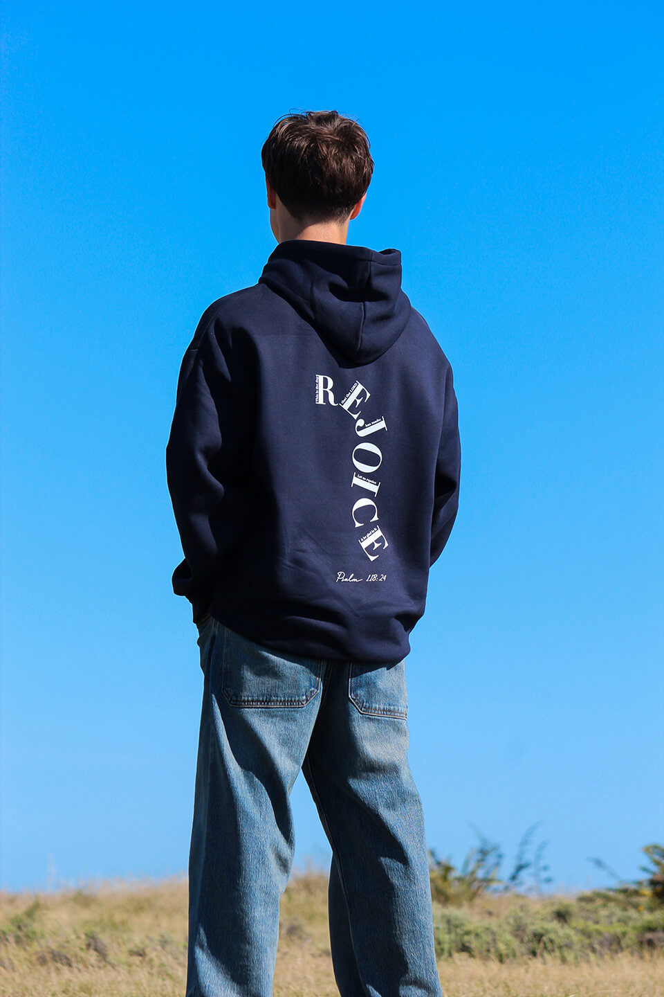 Back of the Sons and Daughters Rejoice Hoodie in Navy