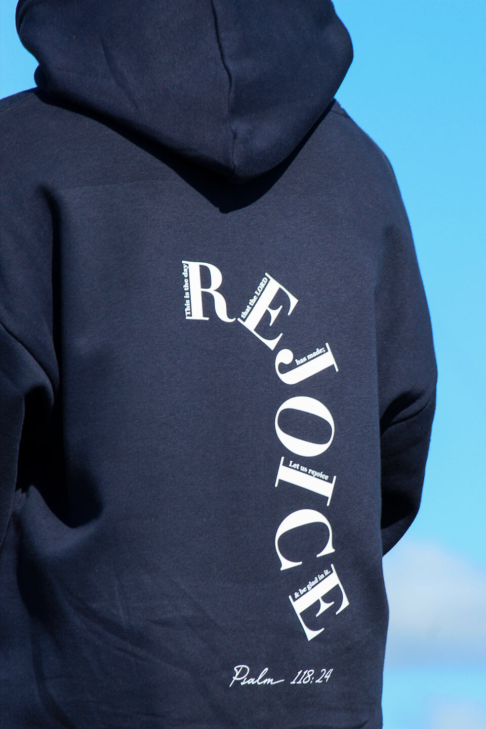 Close up of the back of the Sons and Daughters Rejoice Hoodie in Navy