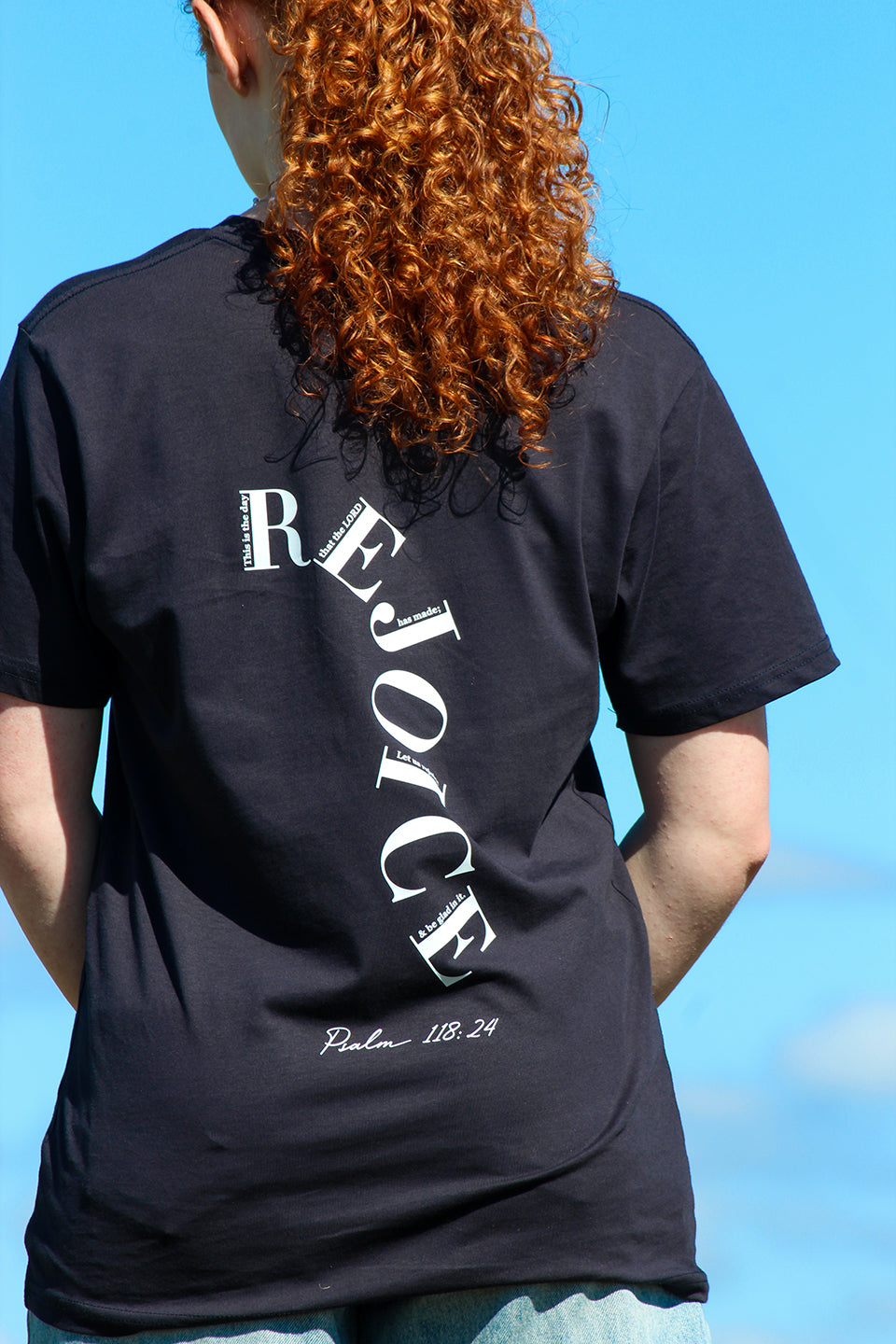 Close up of the back of the Sons and Daughters Rejoice T-shirt in Navy
