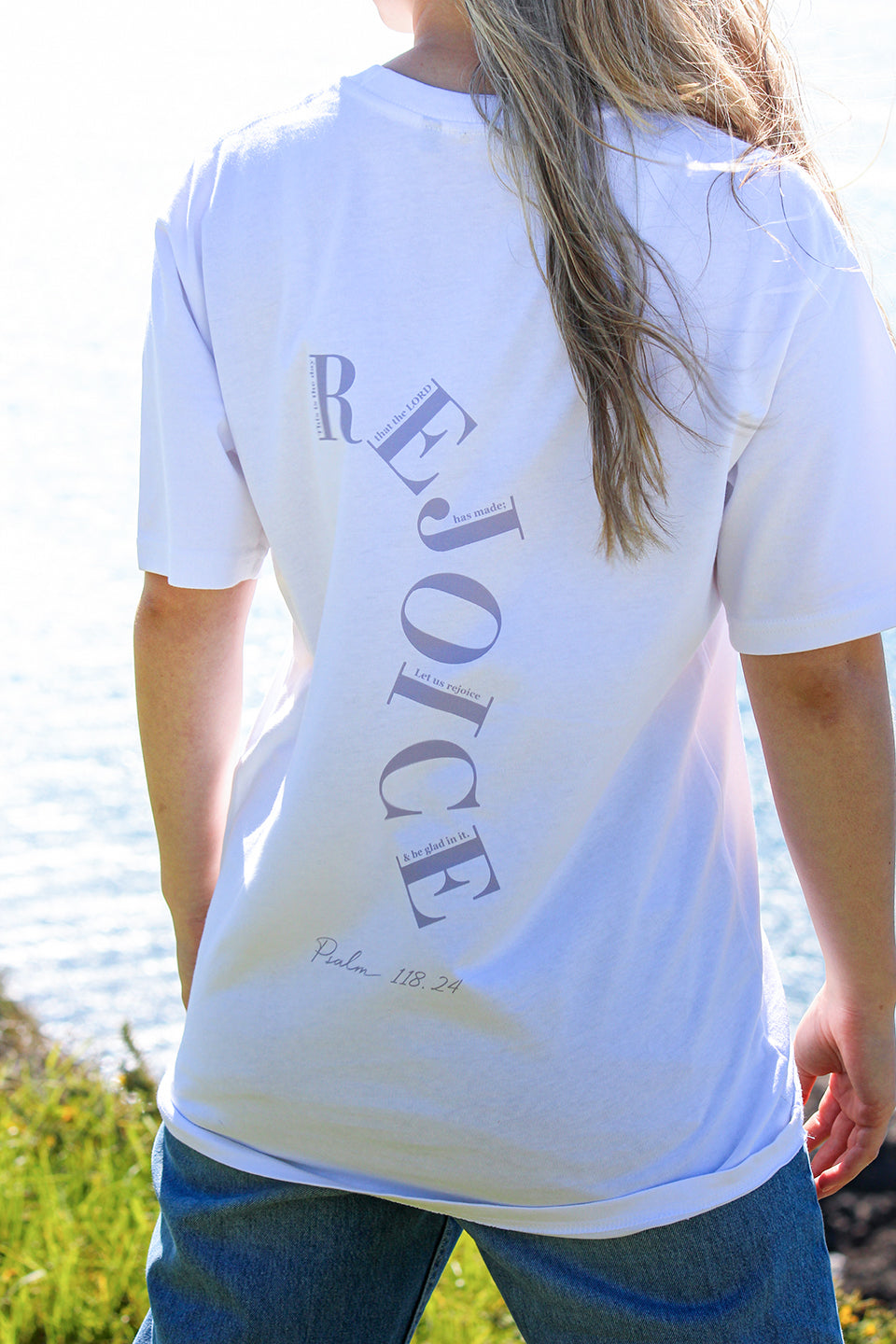 Close up of the back of the Sons and Daughters white T-shirt with purple